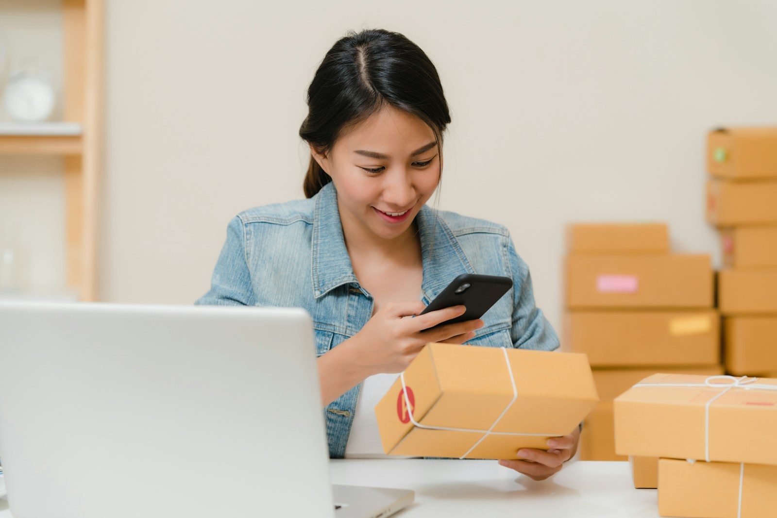 Small business merchant reviewing an order beside packaged products